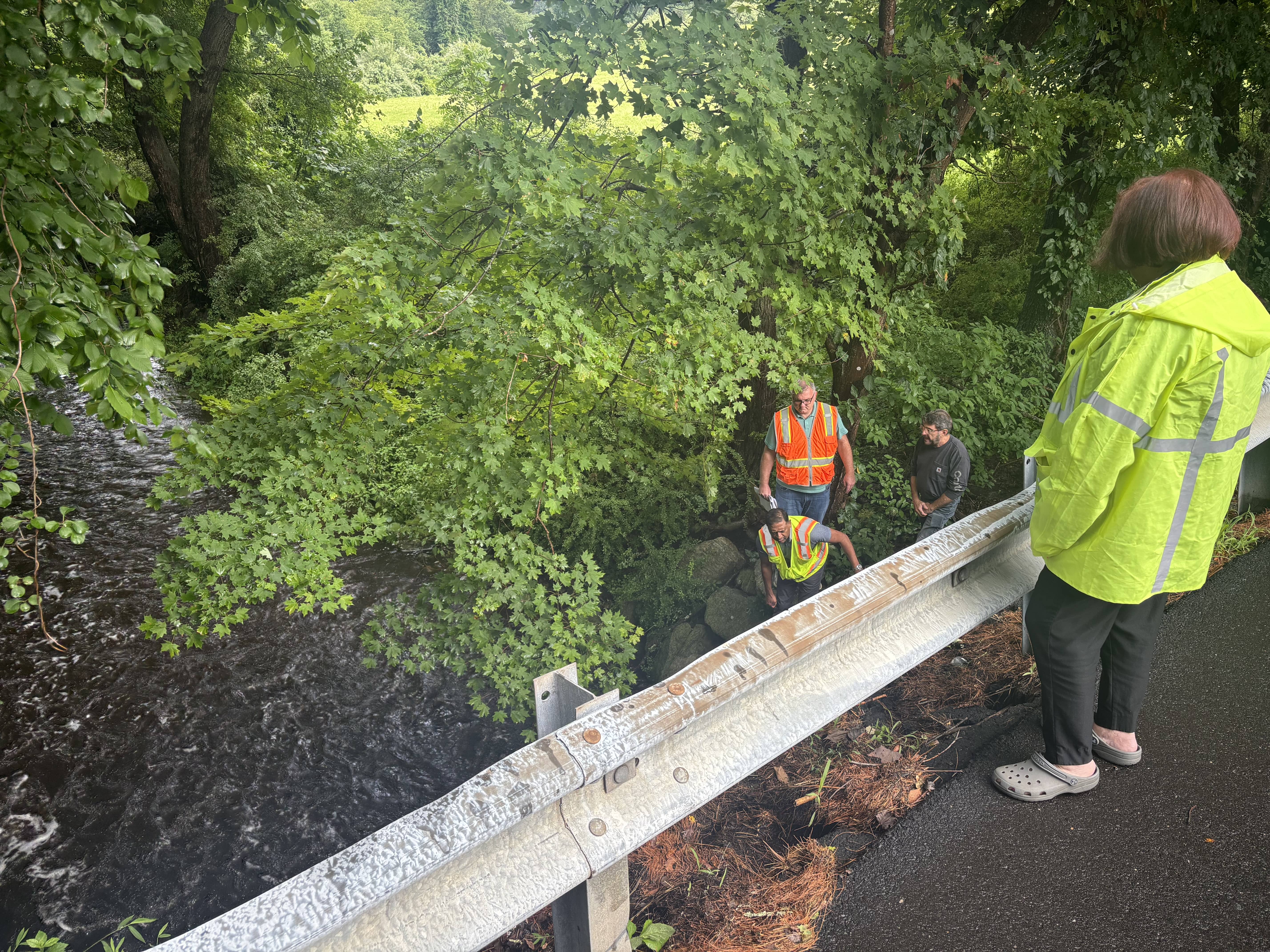Engineers from SLR along with Bethany ZEO Curtis Bosco descend into the culvert beneath Bethmour Road.